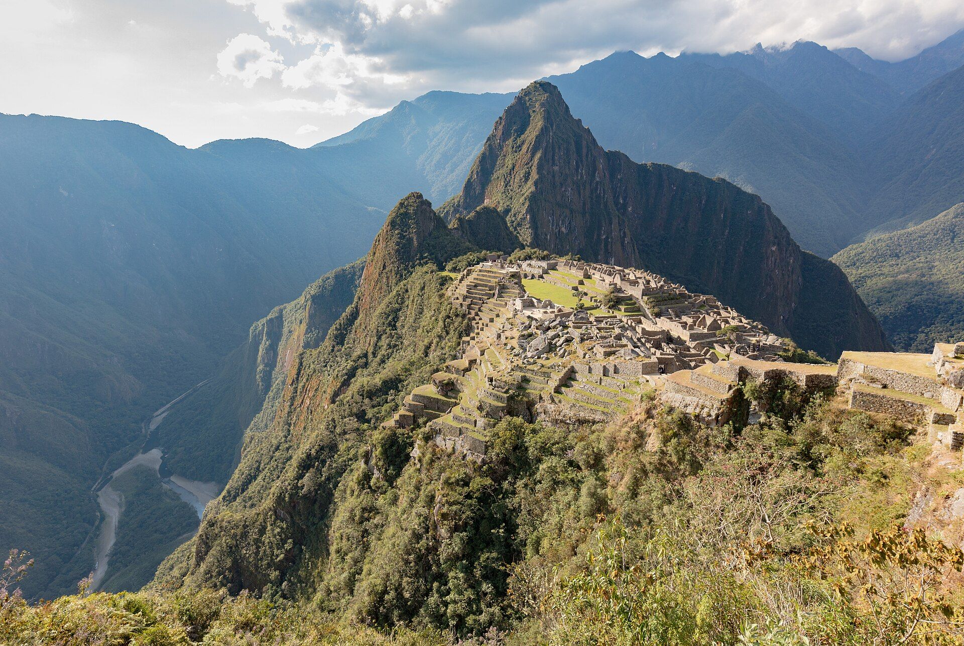 Machu Picchu's city layout, stone buildings and terraces with Huayna Picchu behind